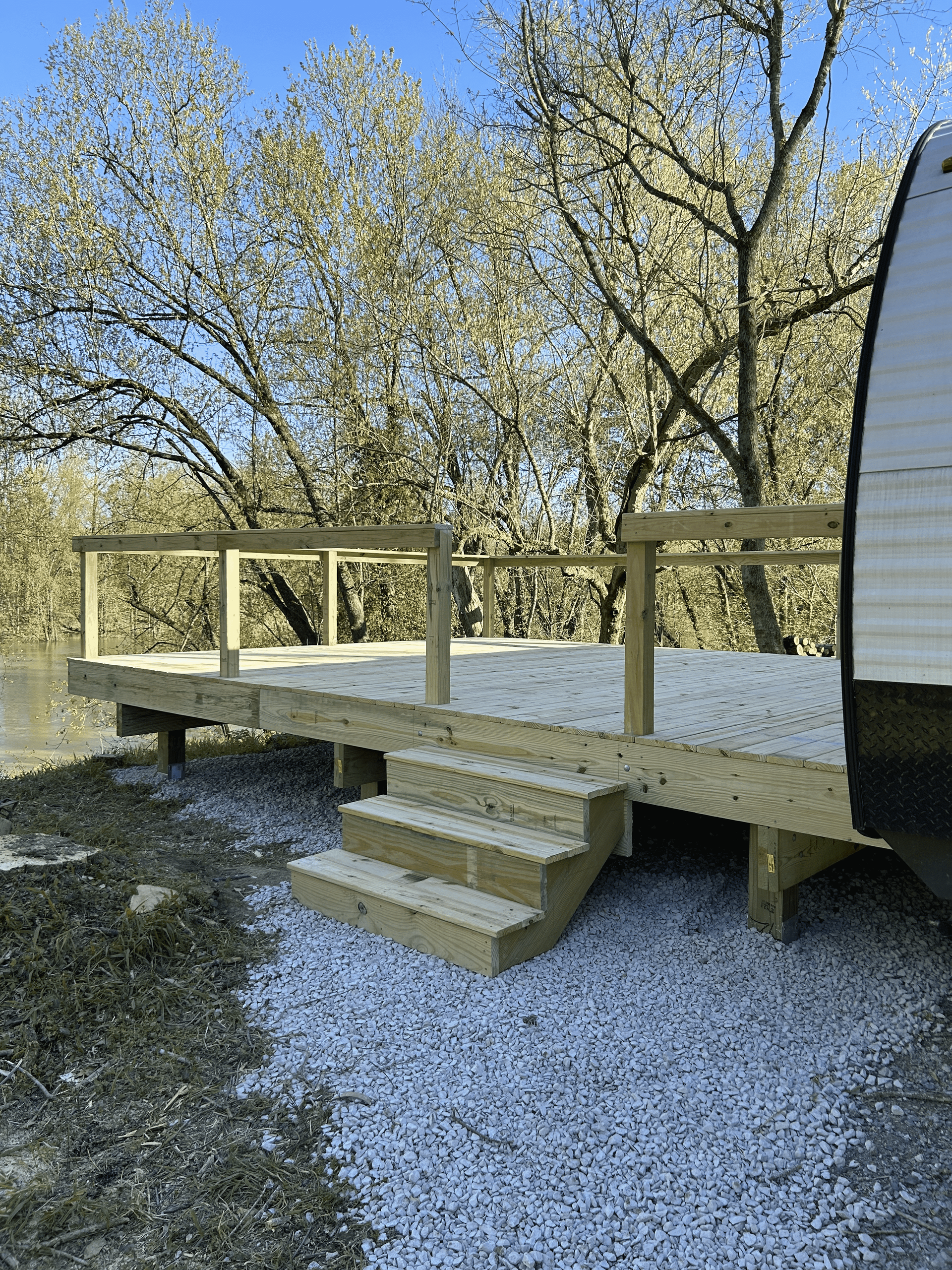 Outdoor deck build in Pendleton – DeckHeadSky custom wood deck with steps and open railing near natural landscape