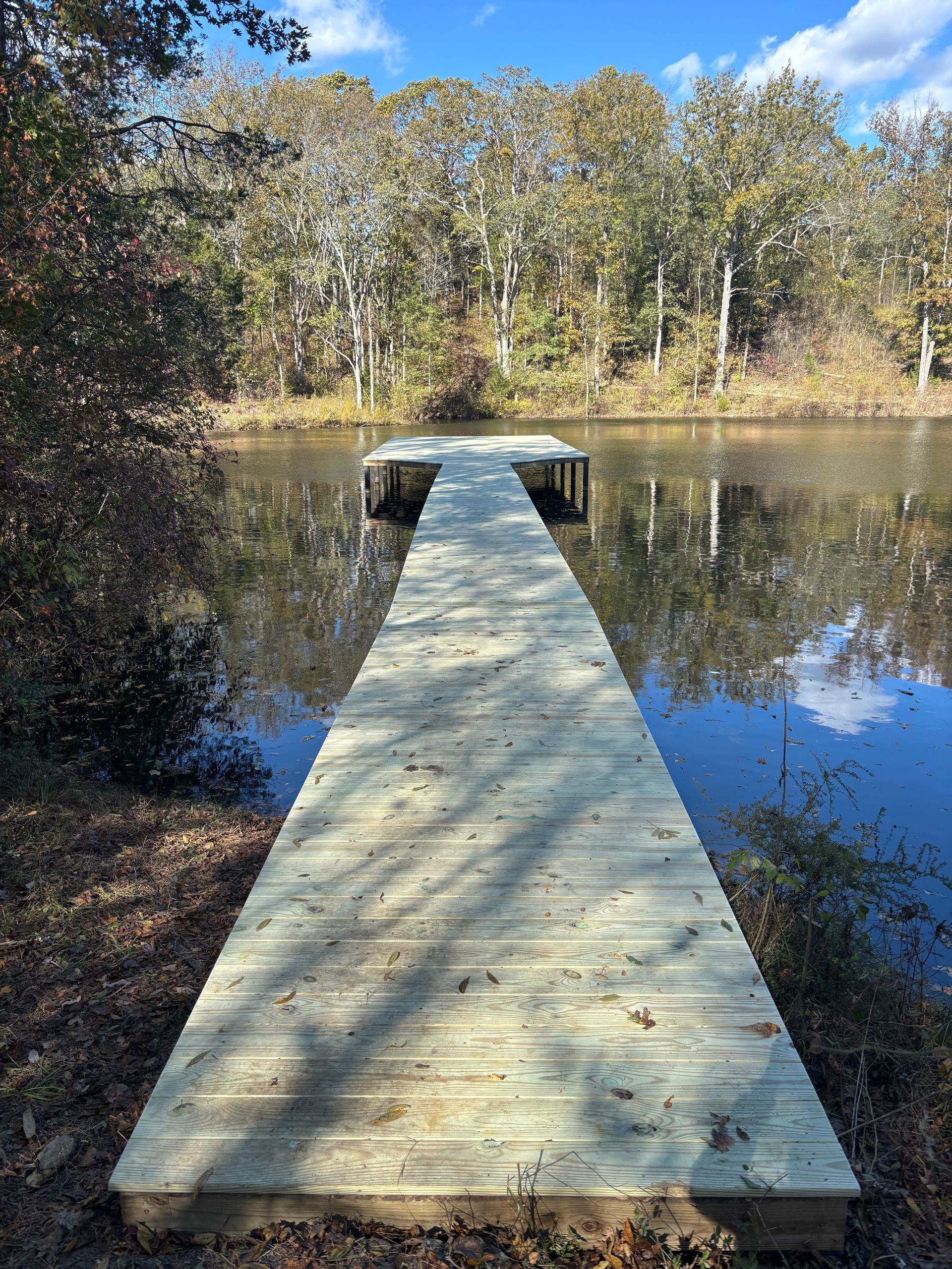 Deck repair service in Pendleton – DeckHeadSky restored outdoor deck with sturdy stairs, black railing, and wood finish