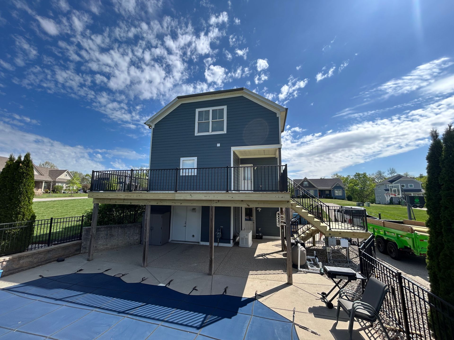Elevated deck with black aluminum railing and under-deck patio in Shelbyville