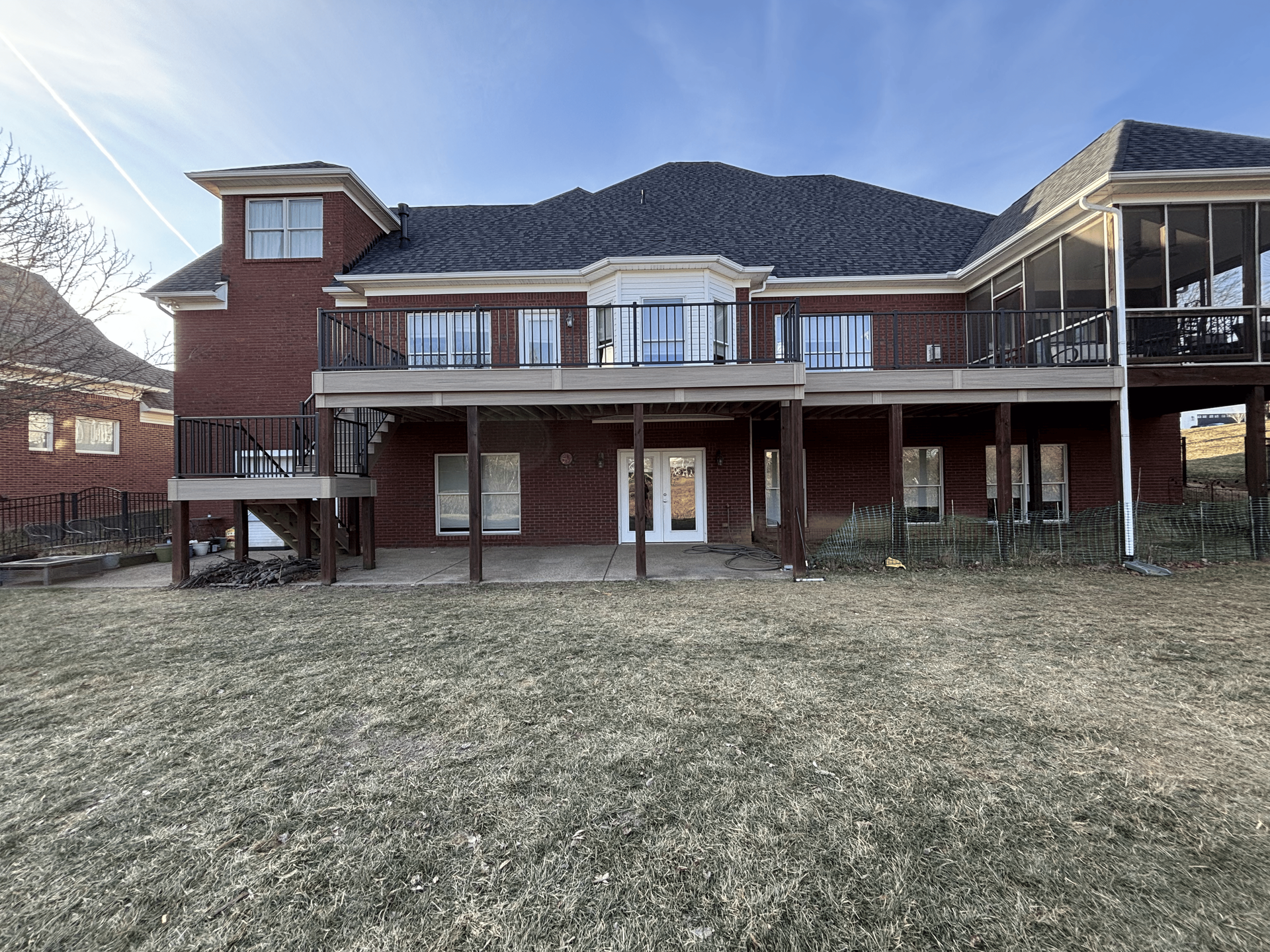 Two-story deck with black railing on a walkout home in Shelbyville