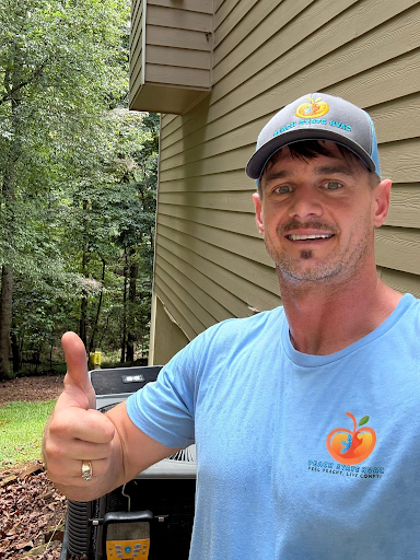 Peach State HVAC owner Derek Granger checking refrigerant pressures on a home AC unit