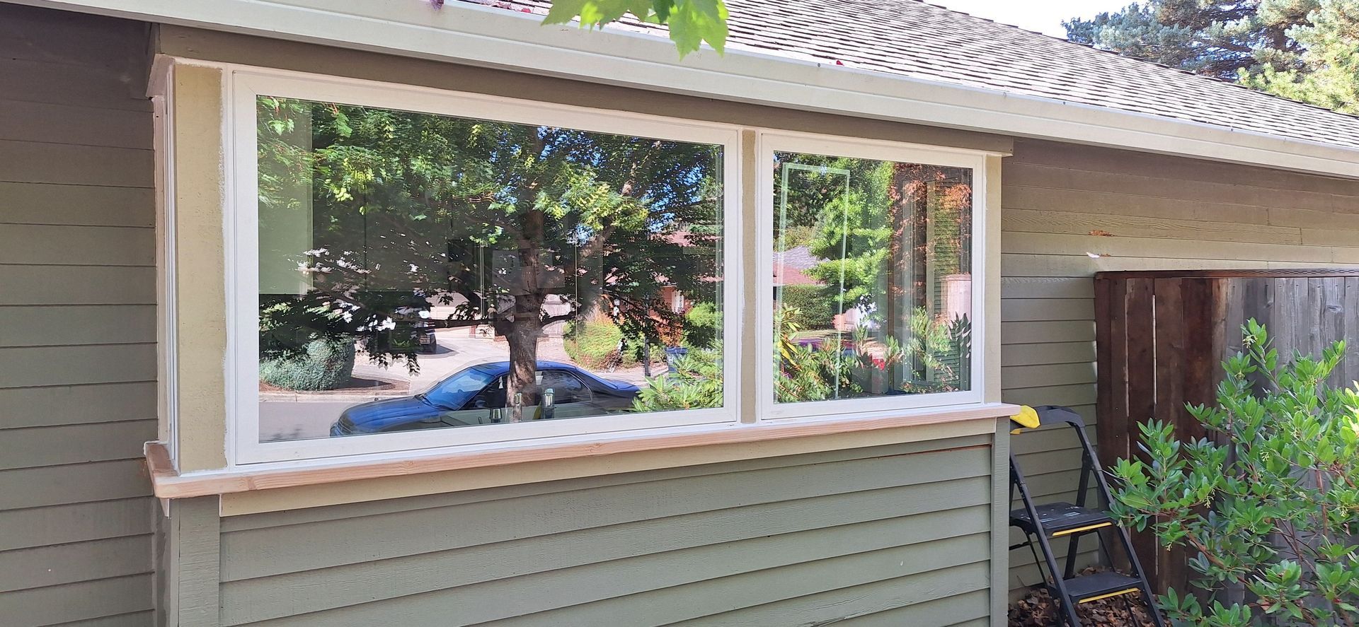 A house with a large window on the side of it.