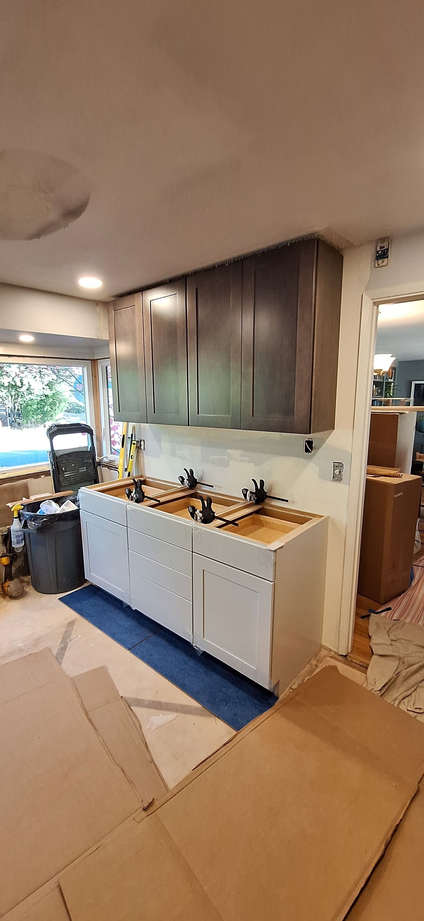 A kitchen under construction with a lot of cabinets and sinks.