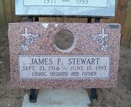 Pink granite grave marker for James P. Stewart with cross carvings and birth and death dates.