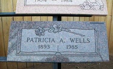 Gravestone for Patricia A. Wells, 1893–1985, gray stone with engraved floral details.