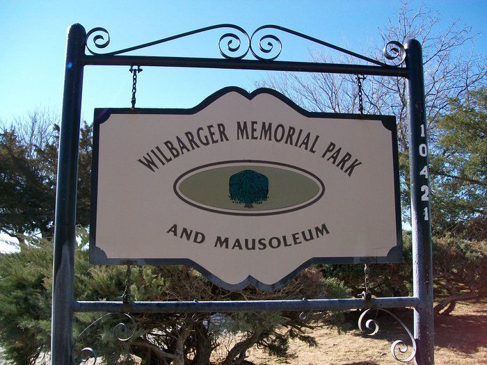Sign for Wilbarger Memorial Park and Mausoleum against a blue sky
