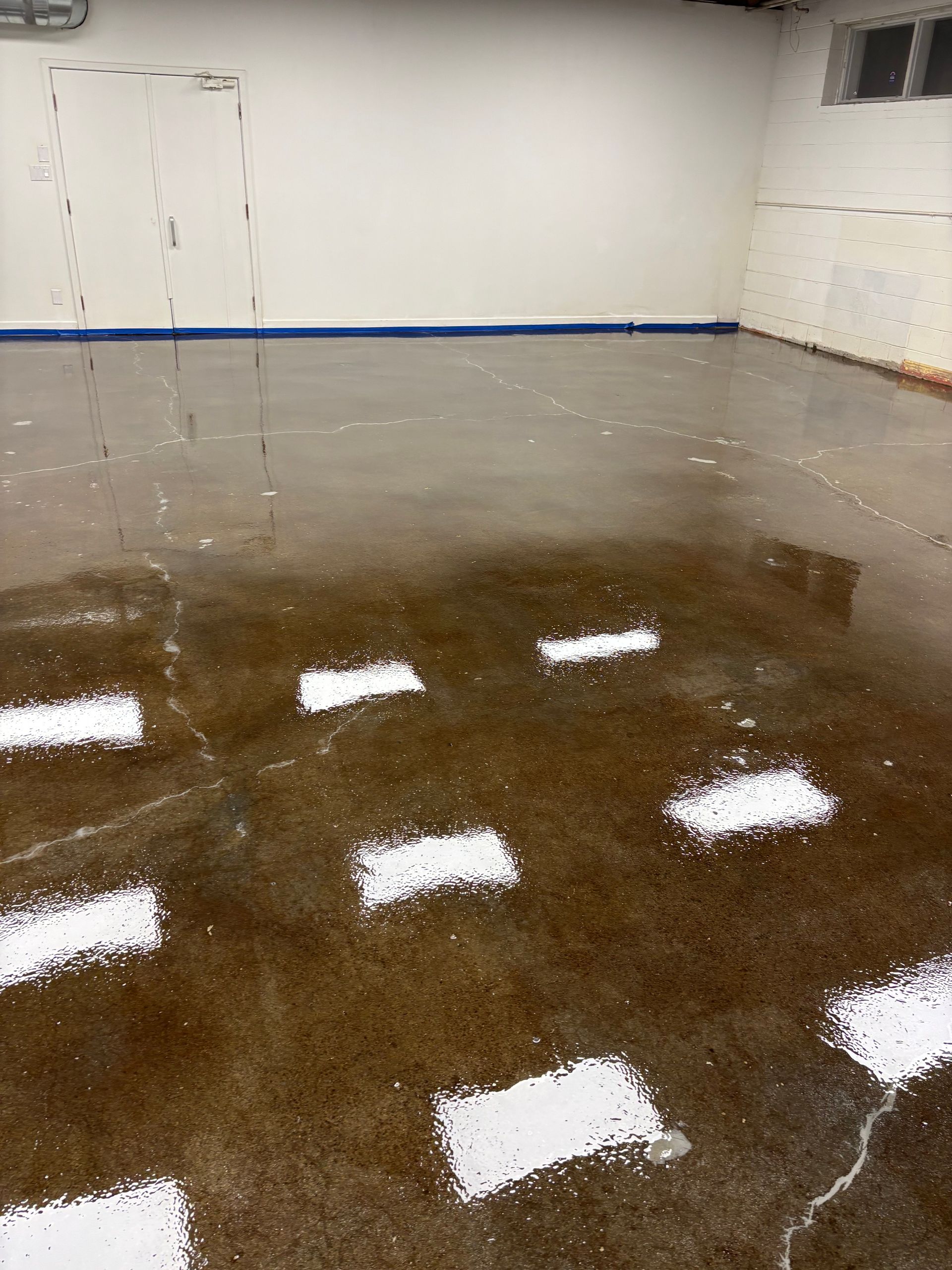 A concrete floor with white arrows on it in a room.