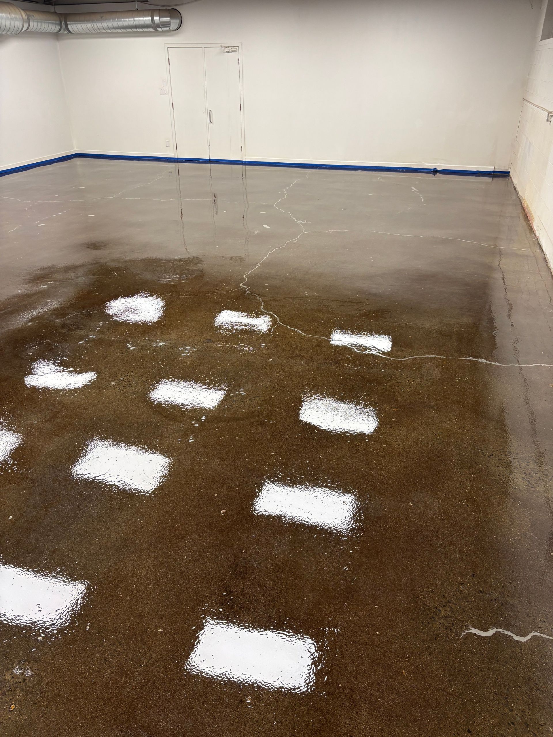 A concrete floor with a lot of white squares on it