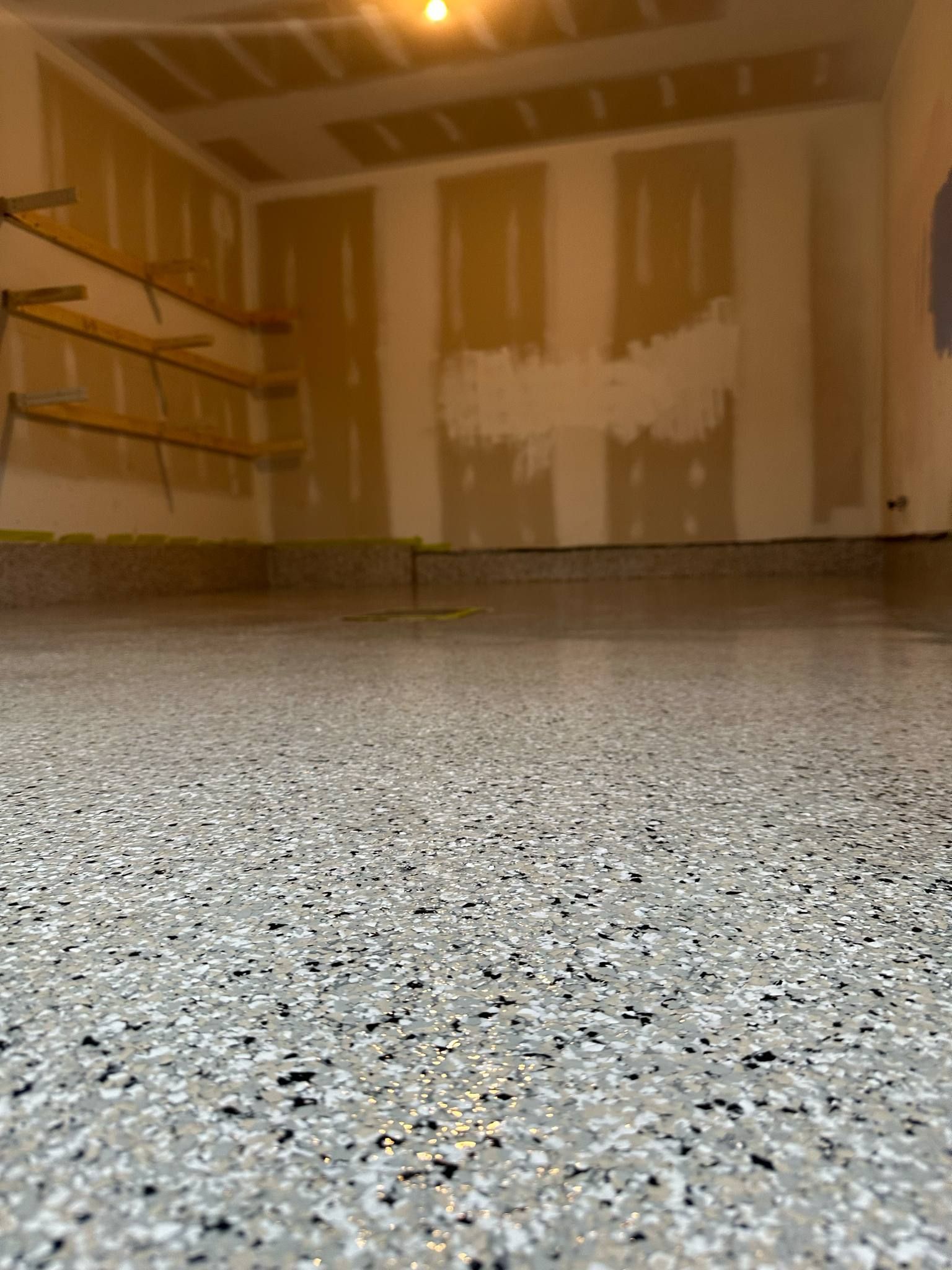 A garage floor with a lot of small stones on it.