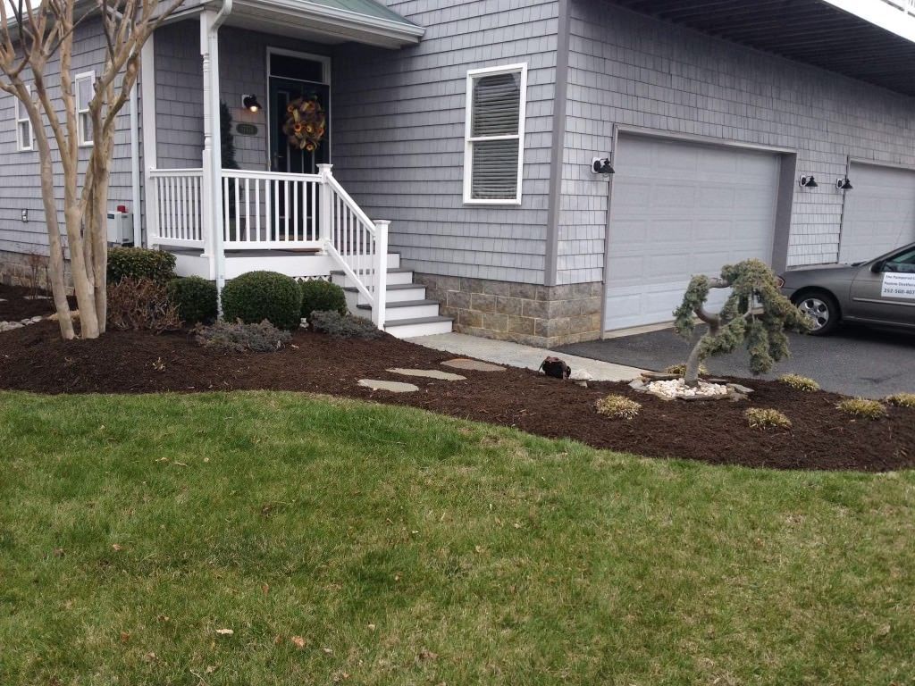 A house with a car parked in front of it