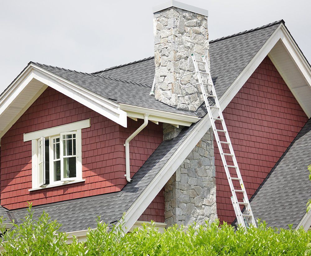 A ladder is attached to the roof of a house