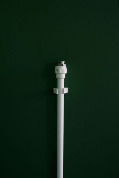 White lamp post centered against a dark green background.