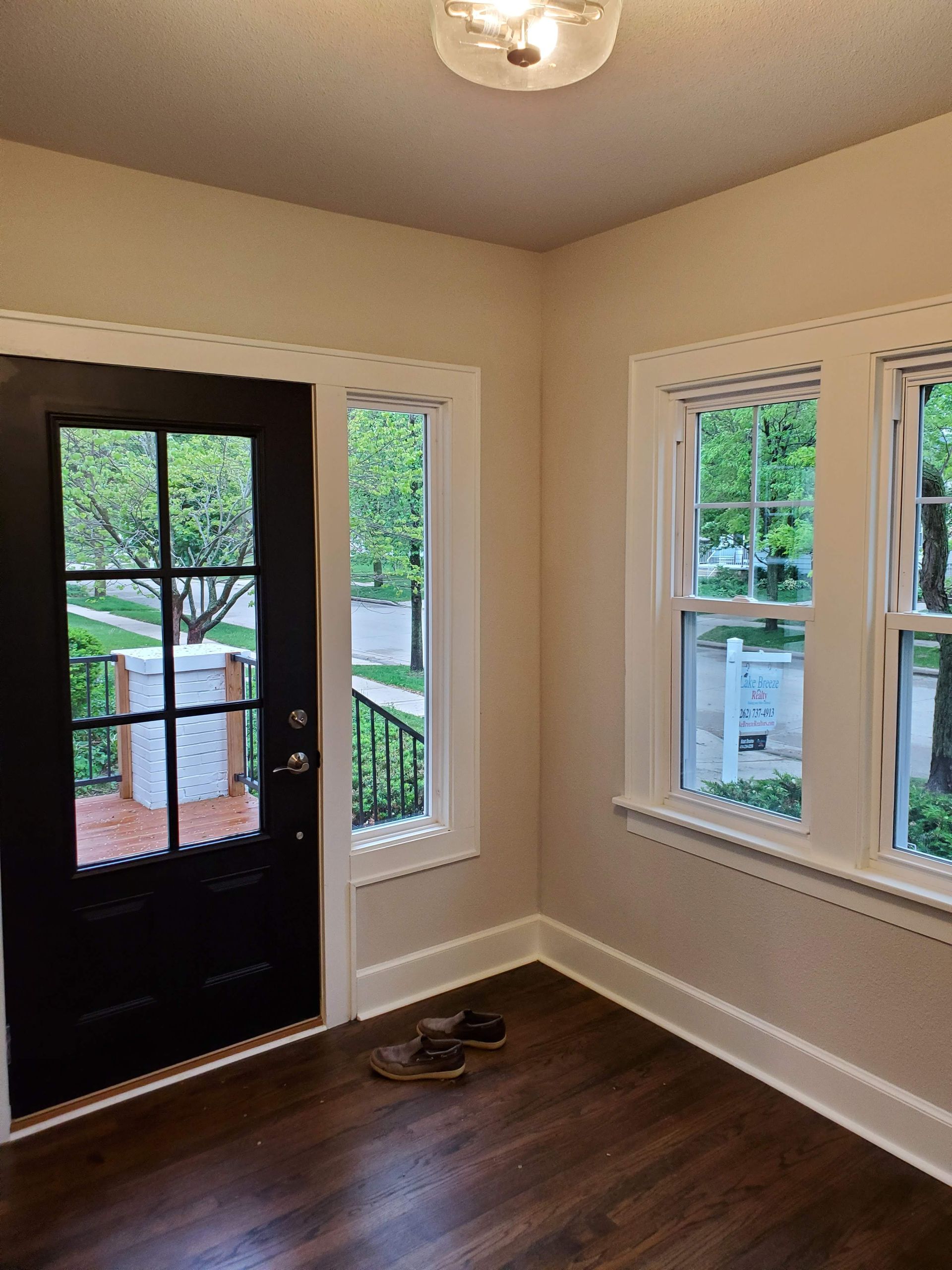 a room with a black door and a lot of windows