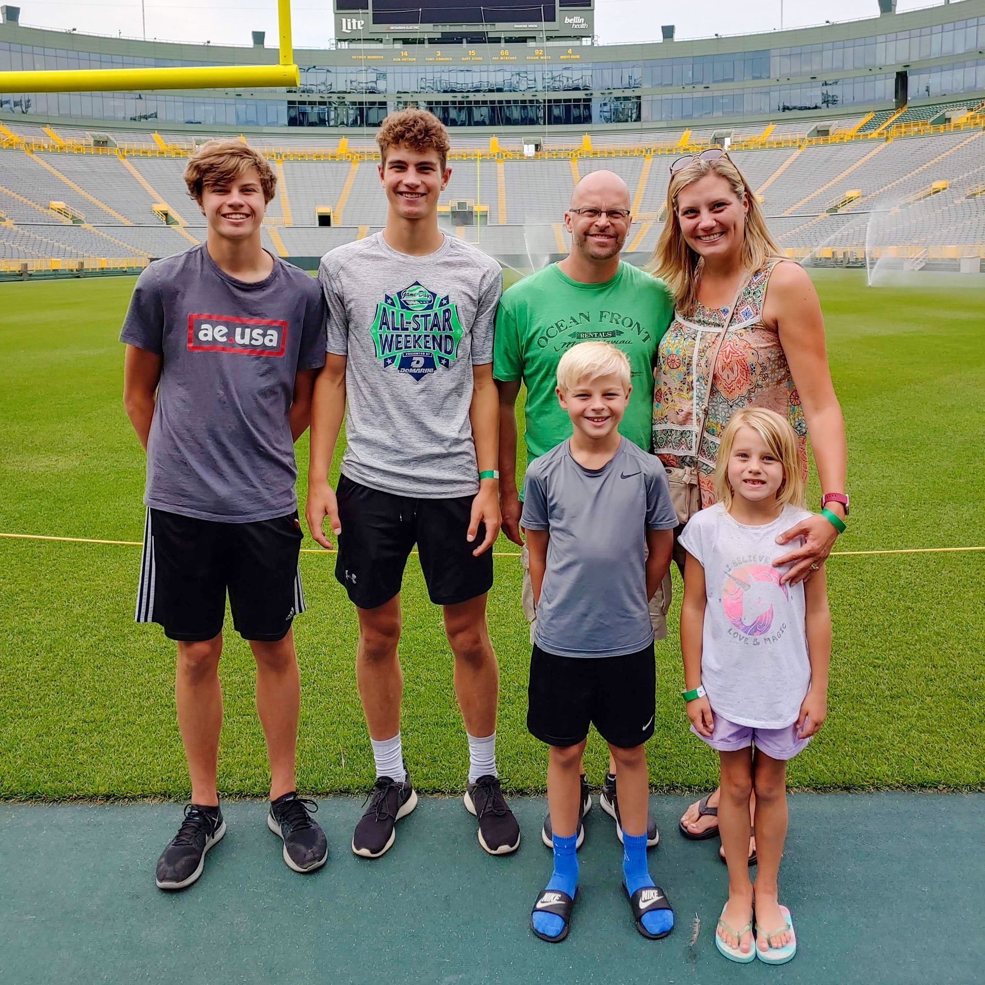 Advantage Matt Bruins and A family posing for a picture on a football field