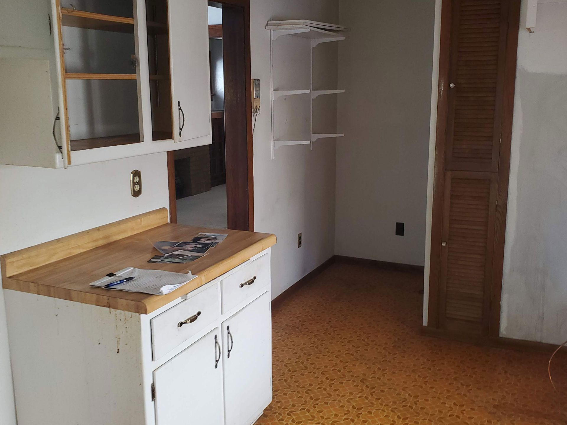an empty bedroom with a carpeted floor and two doors leading to a bathroom .