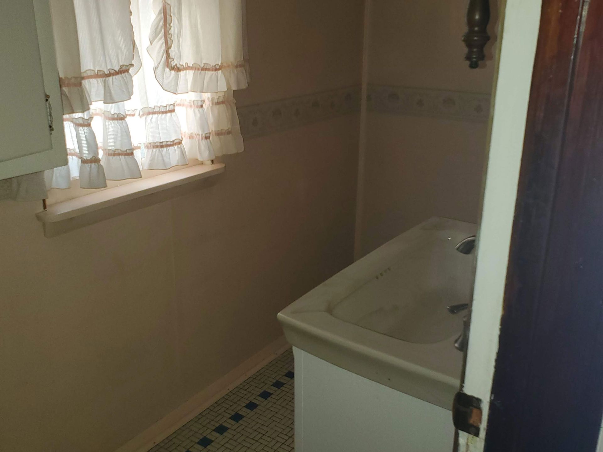 an empty room with a carpeted floor and a window .