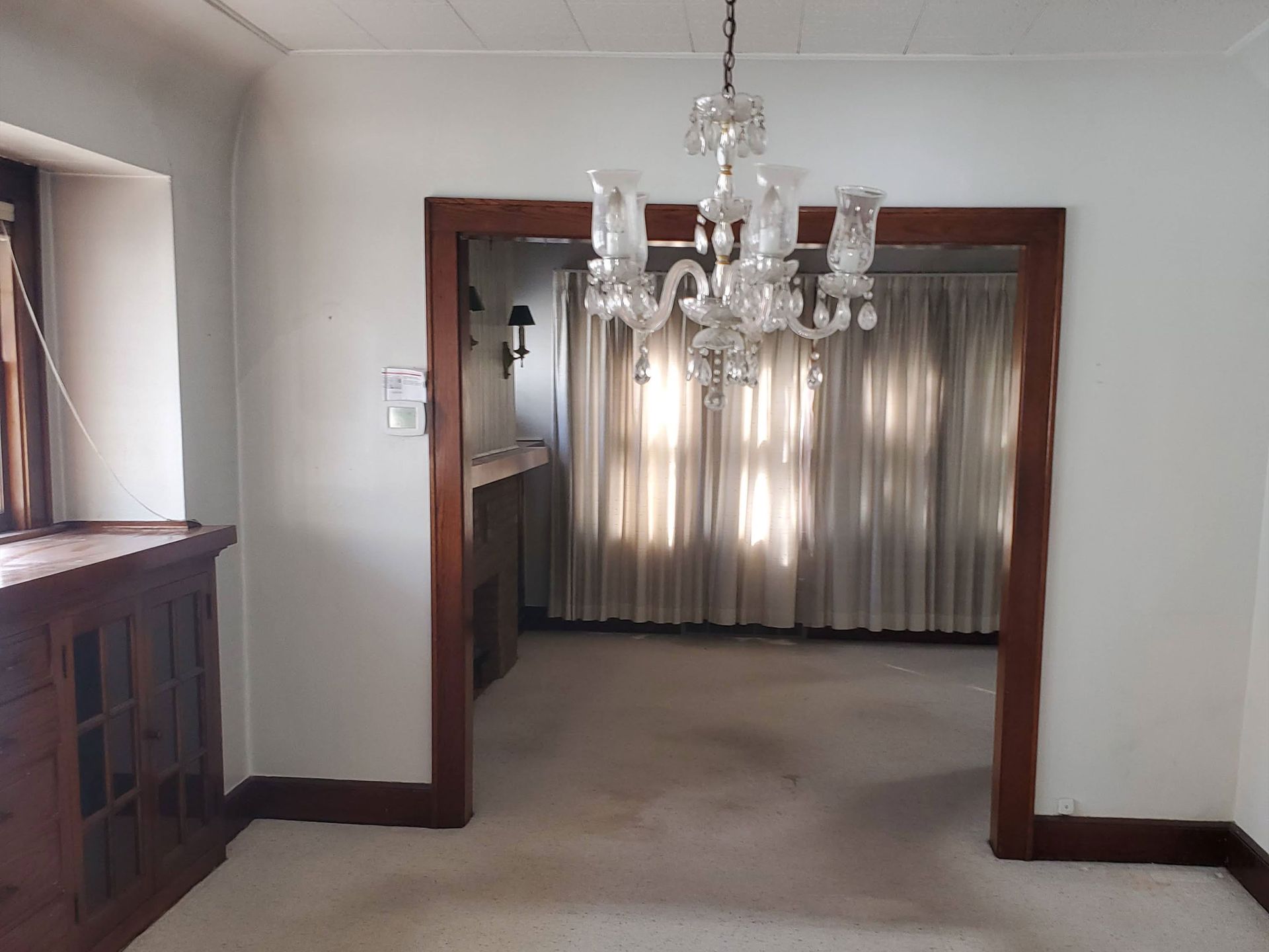 an empty bedroom with a gray carpet and white doors .