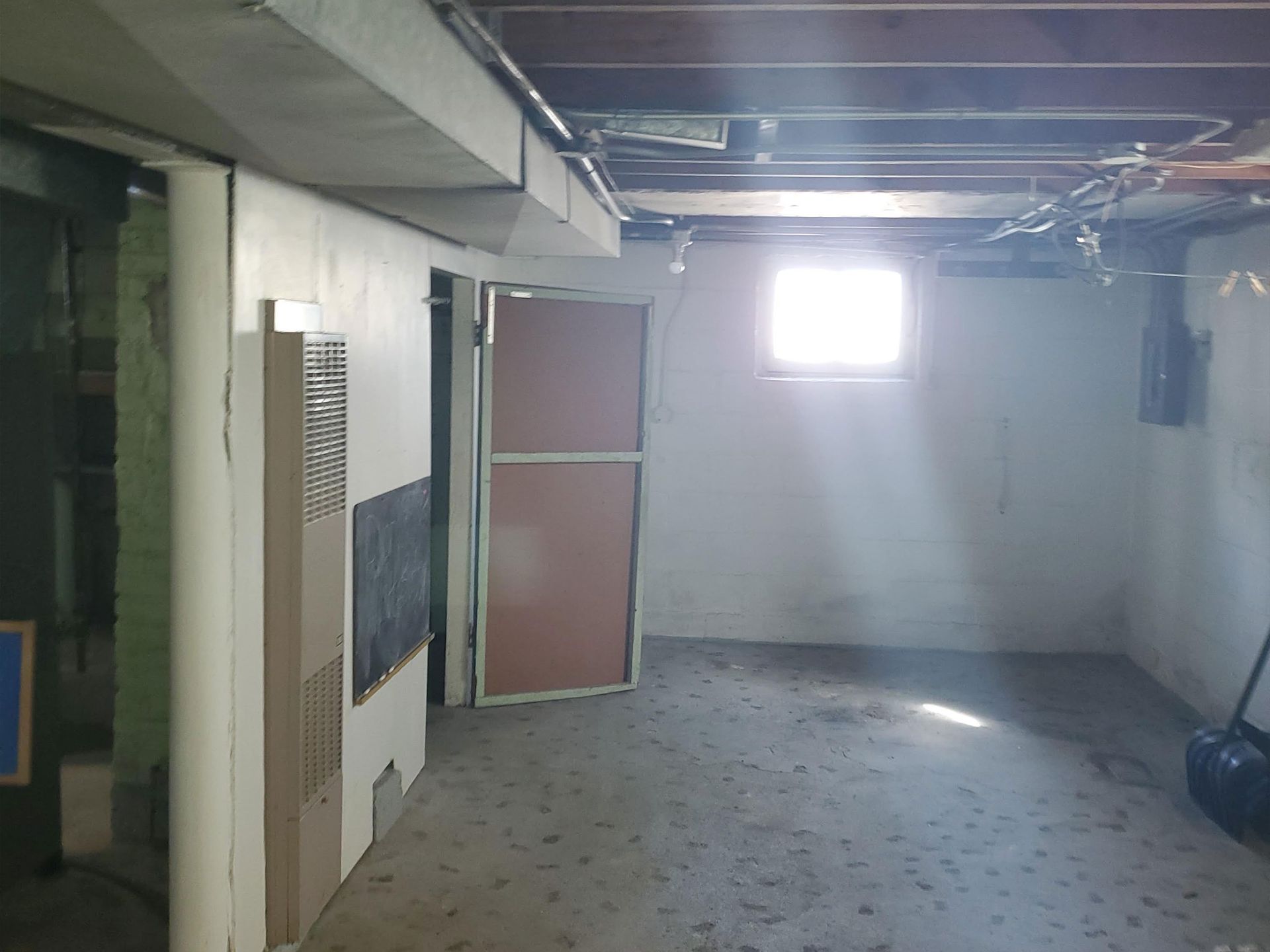 an empty bedroom with a closet and a window .