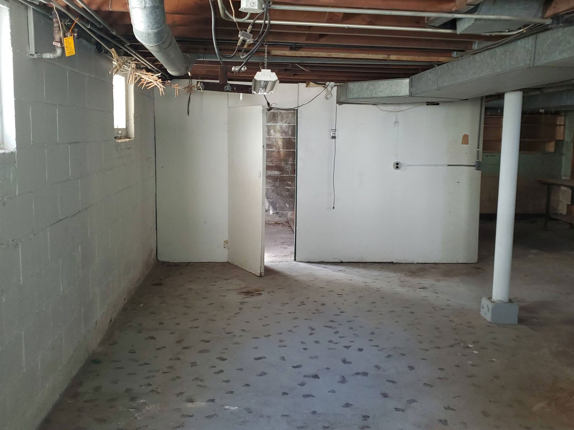 an empty bedroom with a closet and a window .