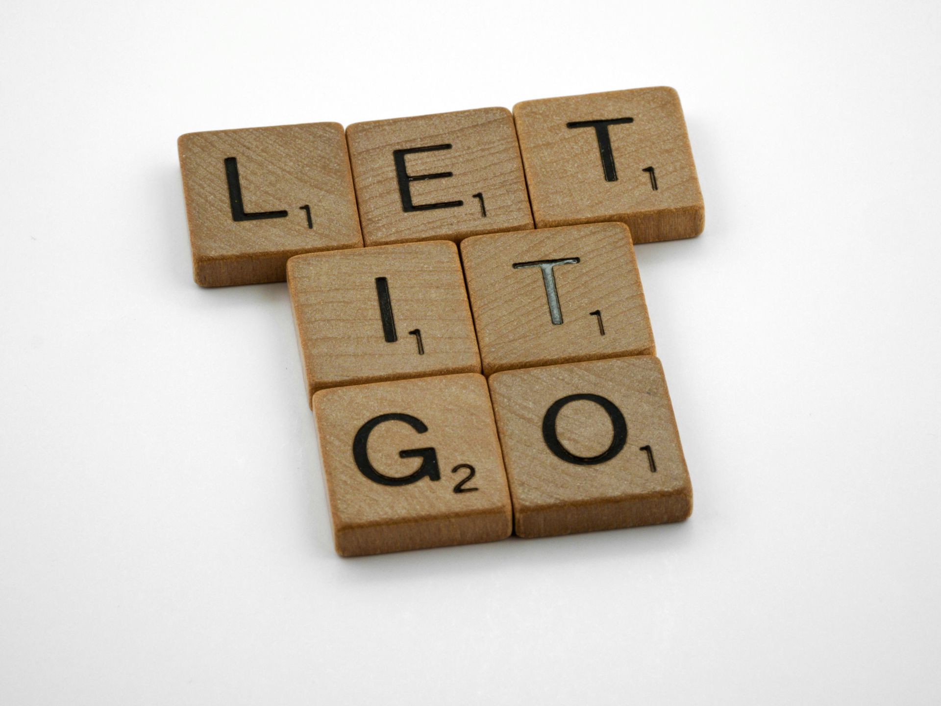 Scrabble tiles arranged to spell “Let It Go.”
