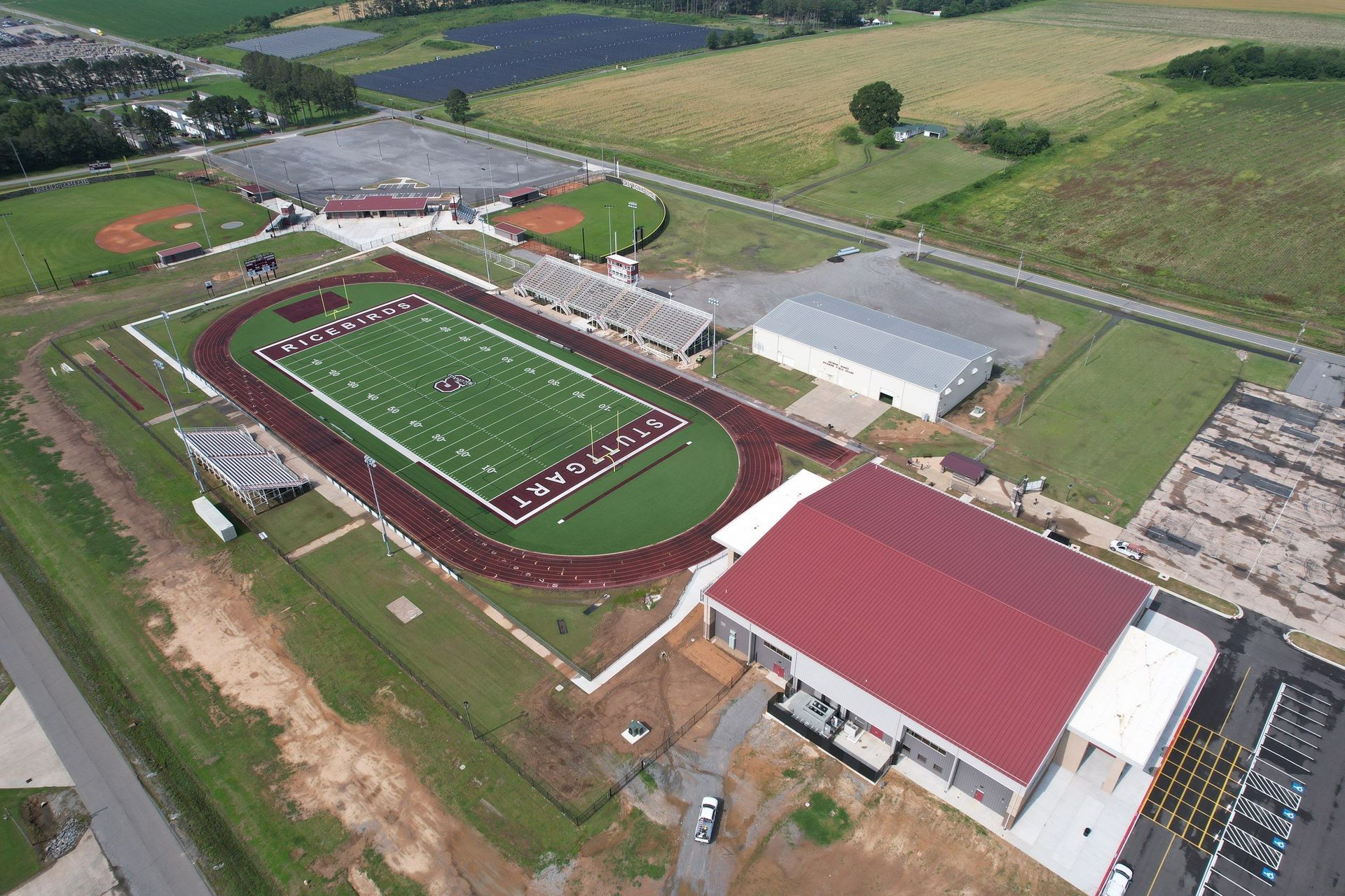 An aerial view of a football stadium with a red roof