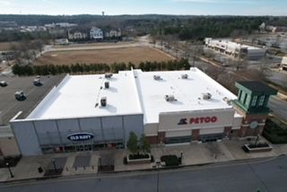 An aerial view of a petco store with a white roof