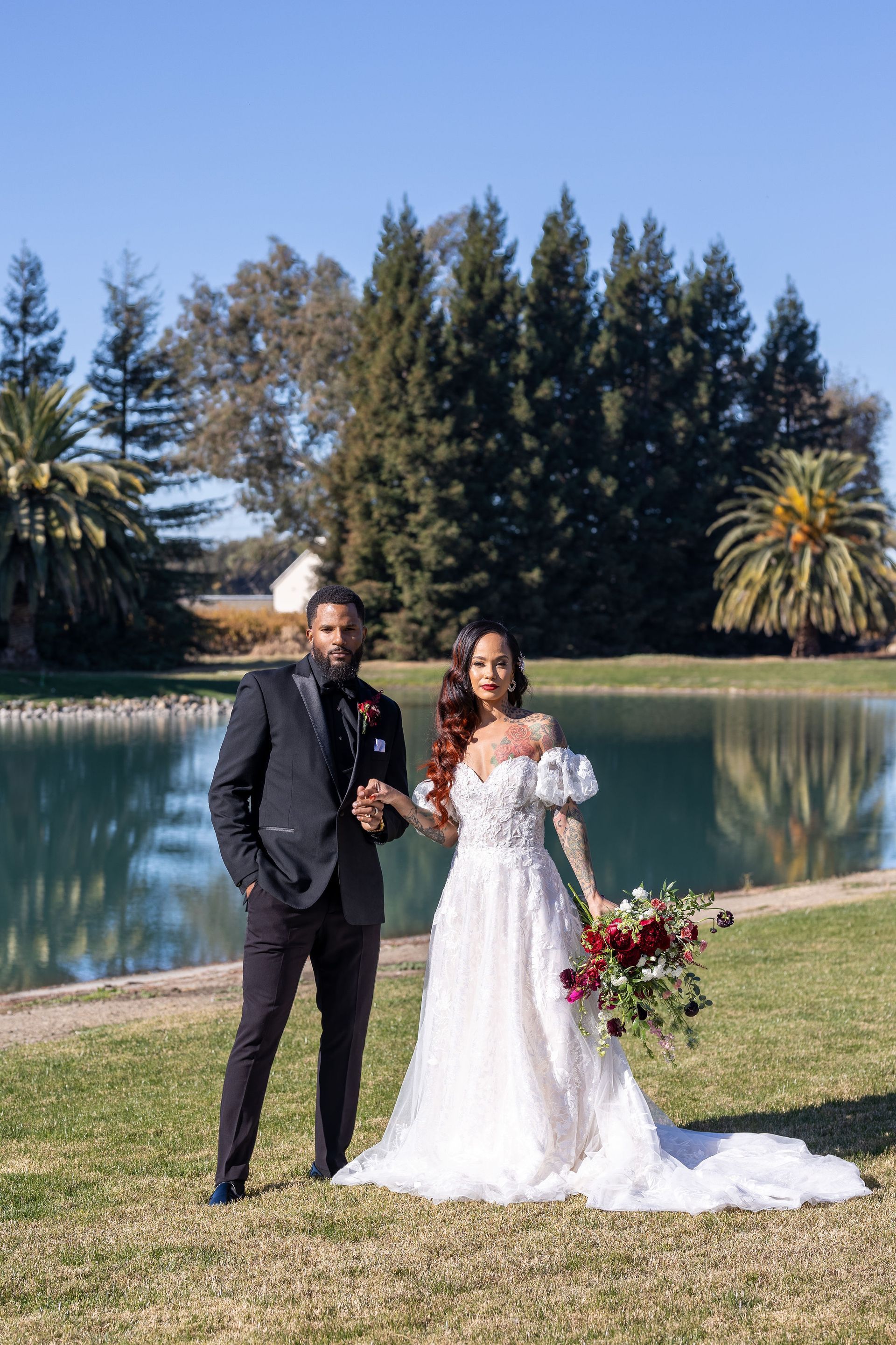 Bride and Groom at Lakeview Estates Wedding Venue in front of lake