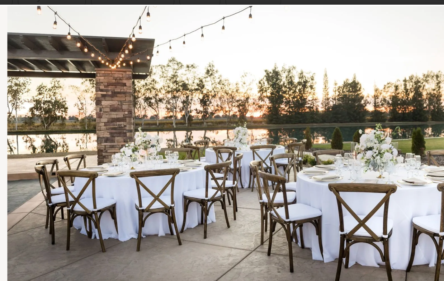Tables and chairs are set up for a wedding reception