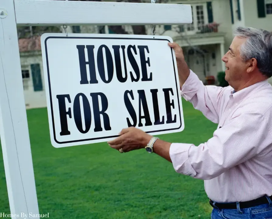 A man is handing a woman a set of house keys