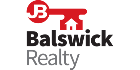 The logo for balswick realty is a red key with an arrow pointing up.
