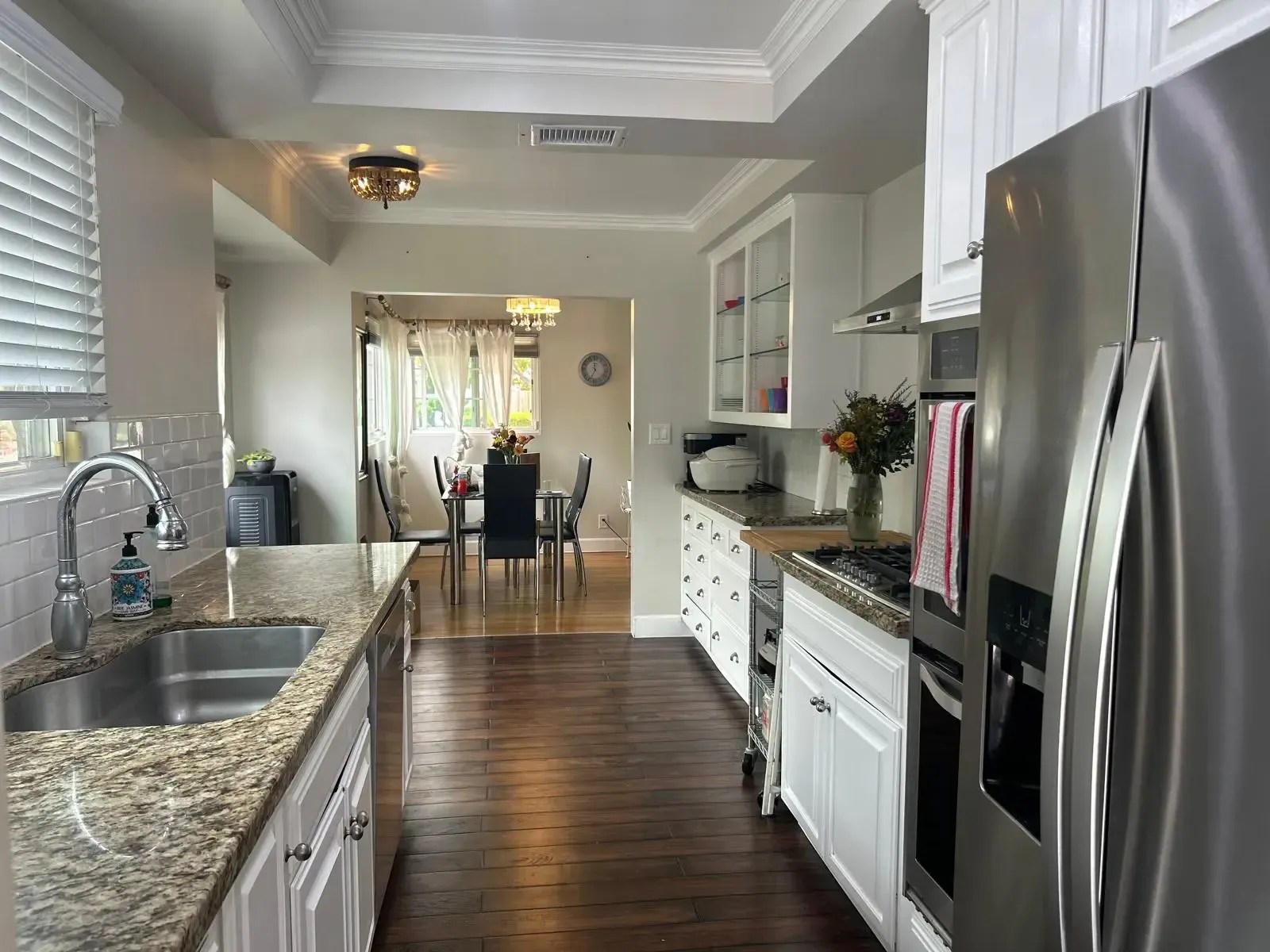 A kitchen with stainless steel appliances and granite counter tops.