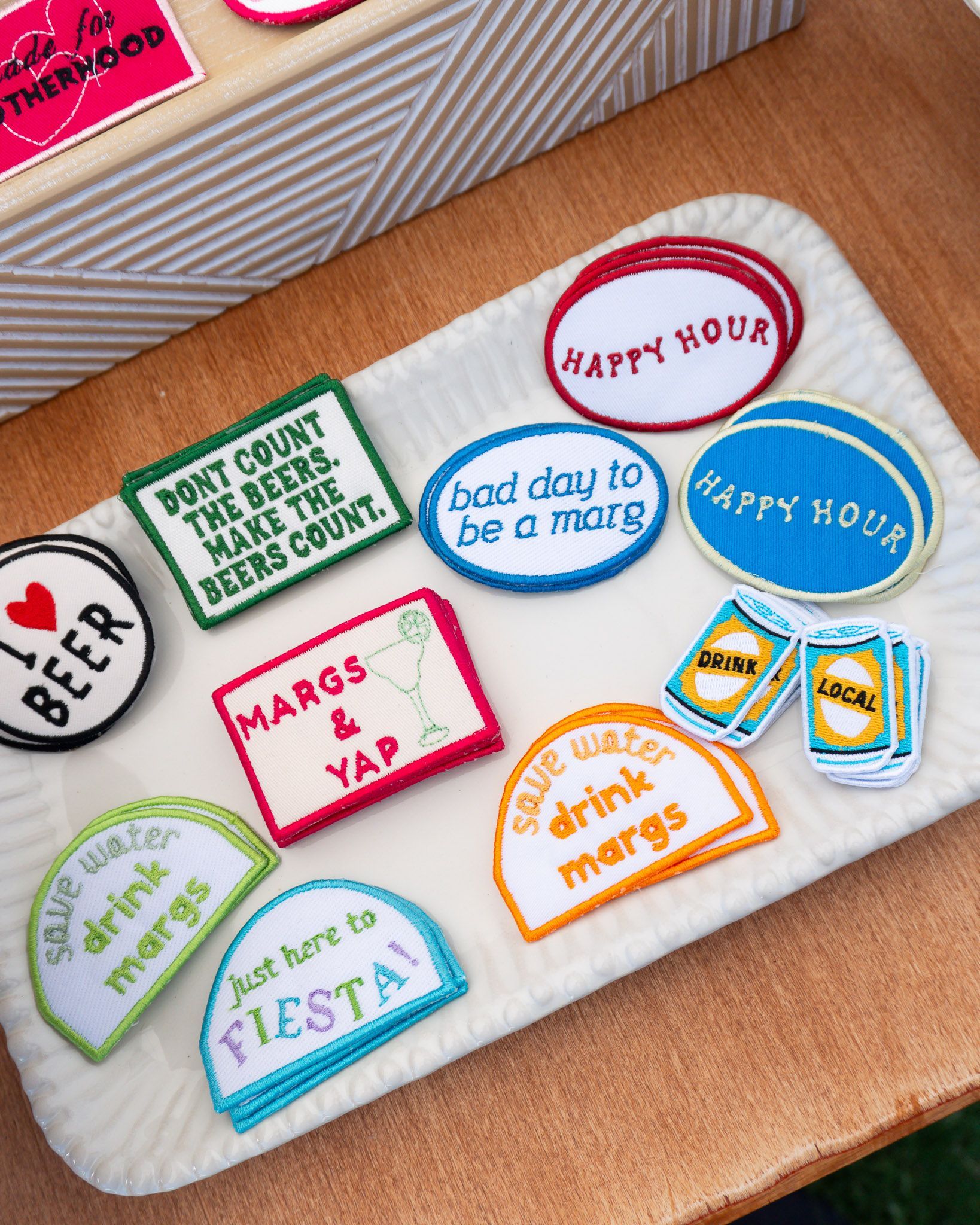 Close-up of embroidered patches available for customizing hats at the Link & Lid custom hat bar.