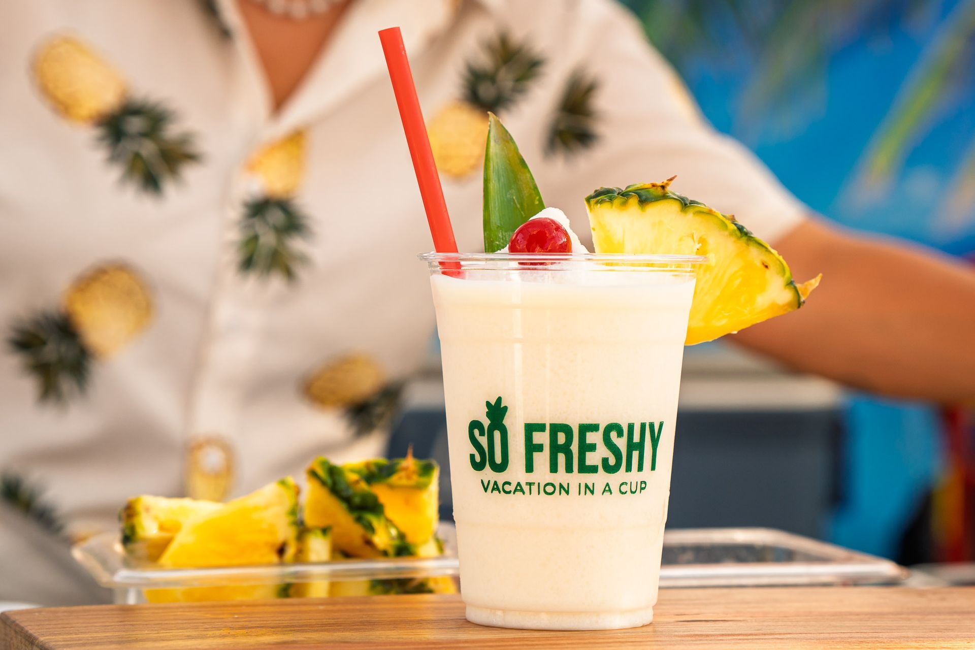 Professional product photography showcasing So Freshy's signature piña colada with fresh pineapple garnish.