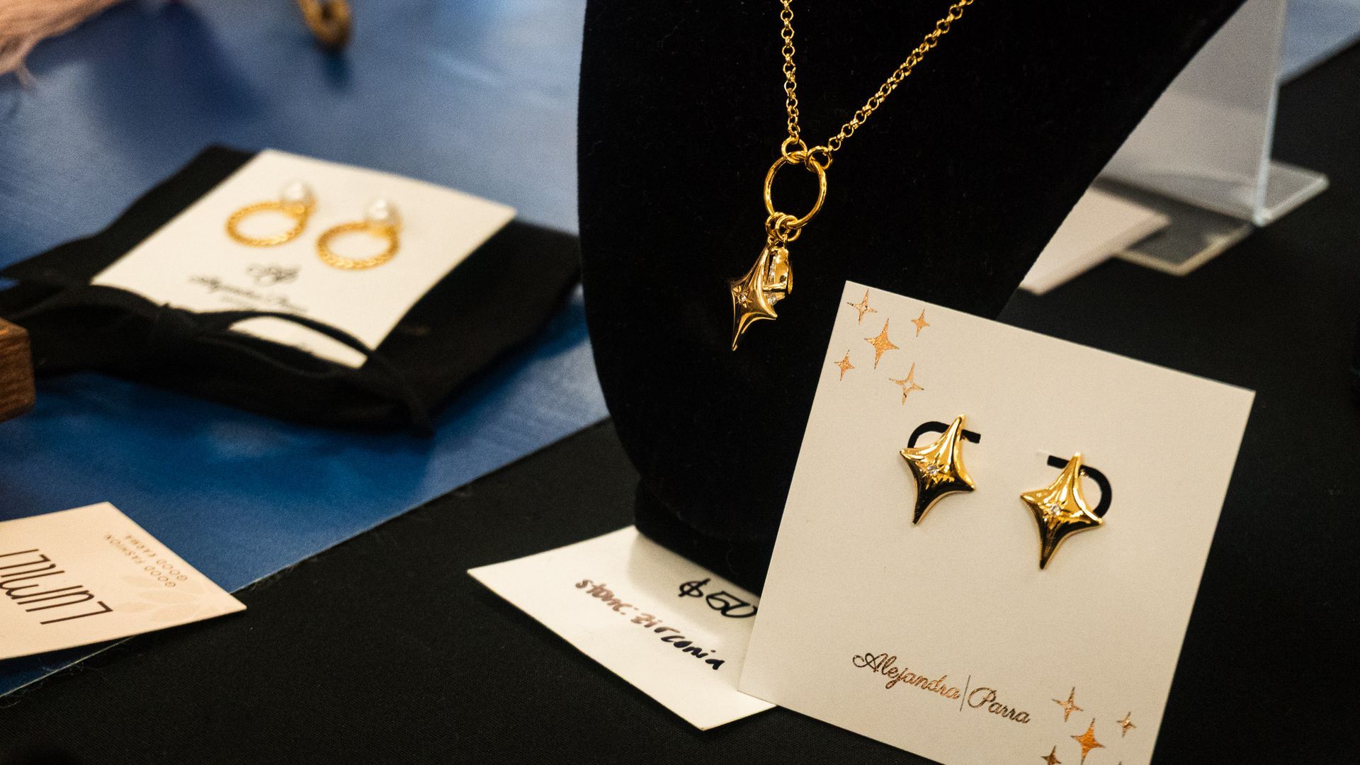 Handcrafted necklace and earrings displayed at My Silver Linings boutique booth during the Tamal & Atole Festival.
