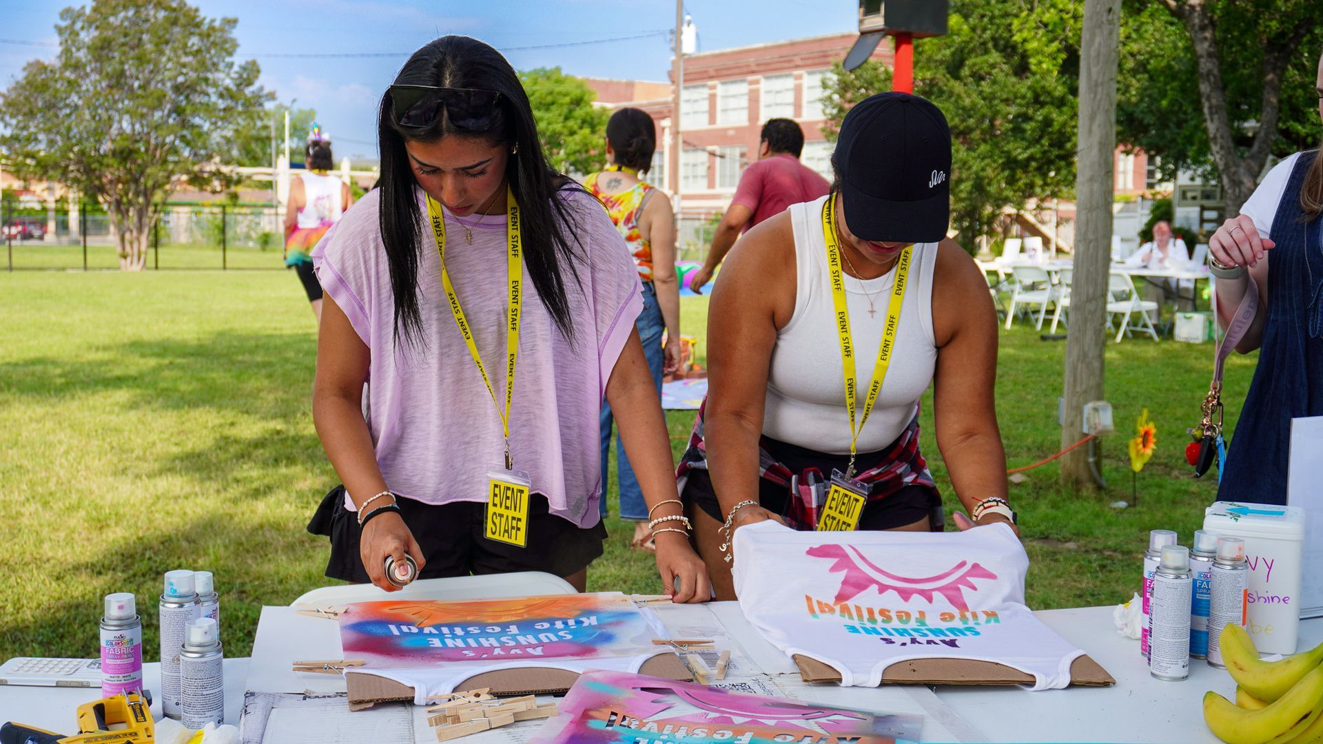 Volunteers leading a hands-on activity at the Avy's Sunshine Kite Festival in Dallas, captured by Hermoso Creations.