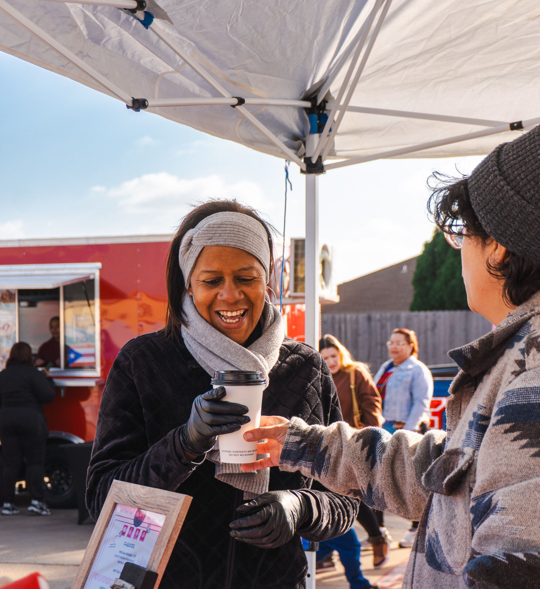 Customer enjoying a handcrafted non-alcoholic piña colada from So Freshy during Bloom Bazaar.
