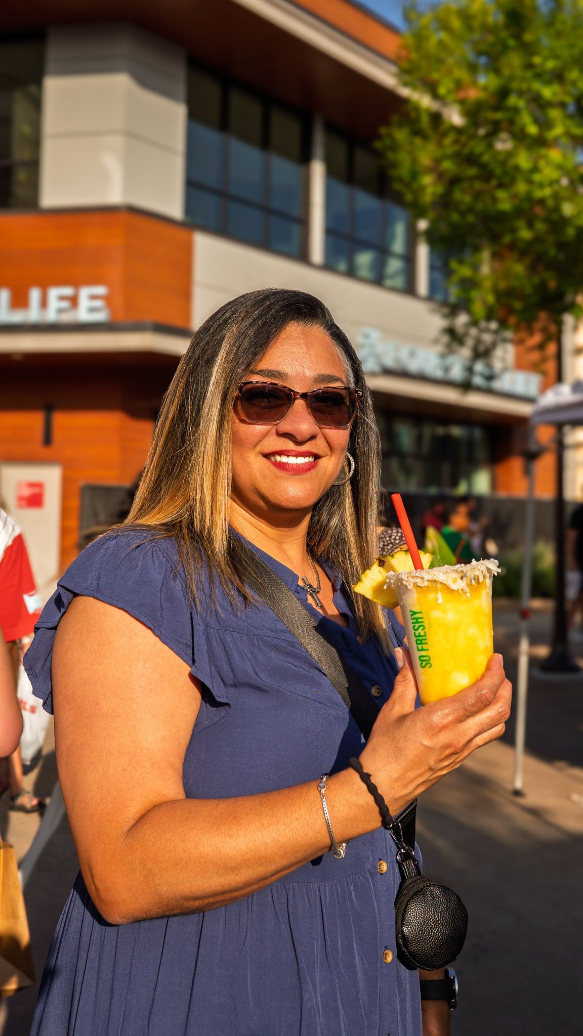 Customer enjoying a handcrafted non-alcoholic piña colada from So Freshy during Bloom Bazaar.