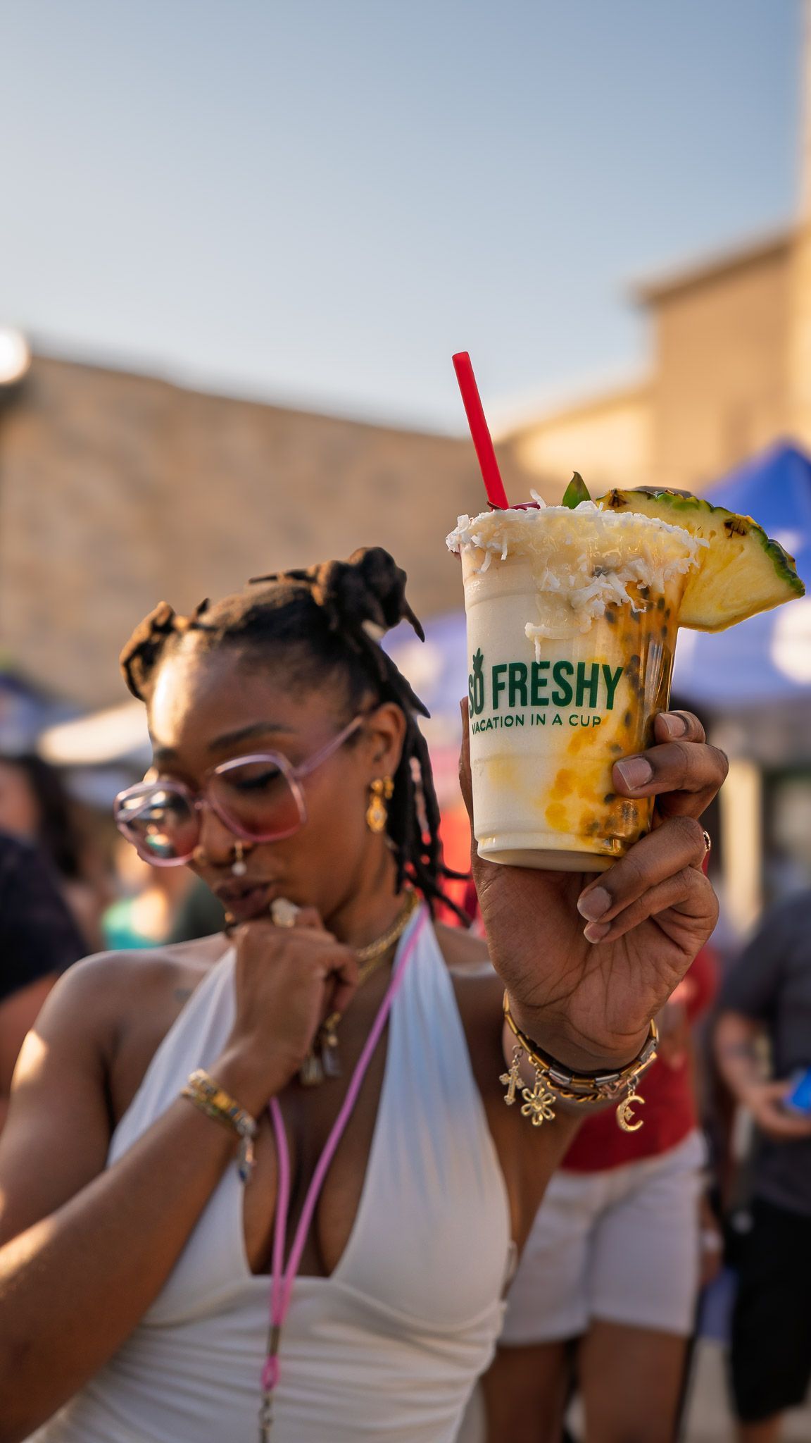 Customer with handcrafted non-alcoholic piña colada from So Freshy during Bloom Bazaar.