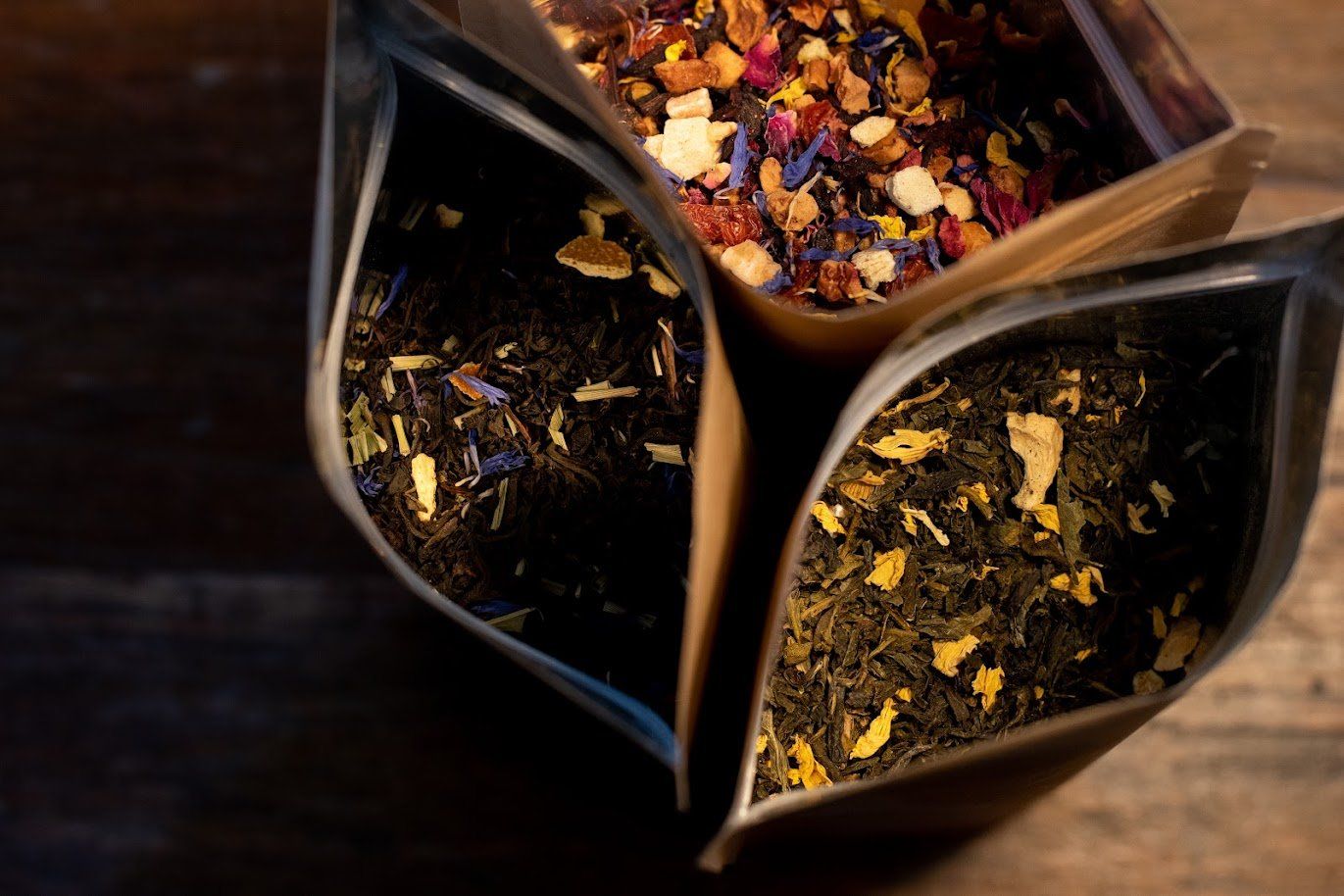 A close-up of three bags full of different kinds of tea
