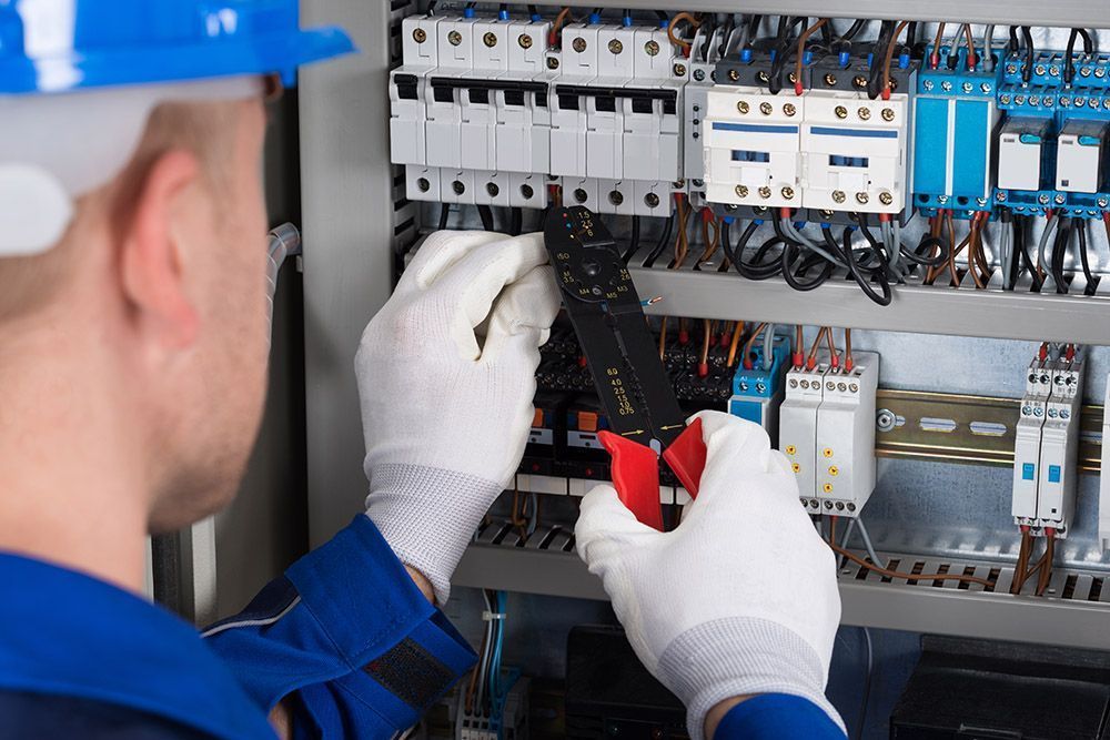 A Person Work on Electrical Wiring — Premiair Refrigeration, Air Conditioning & Electrical in Tamworth, NSW