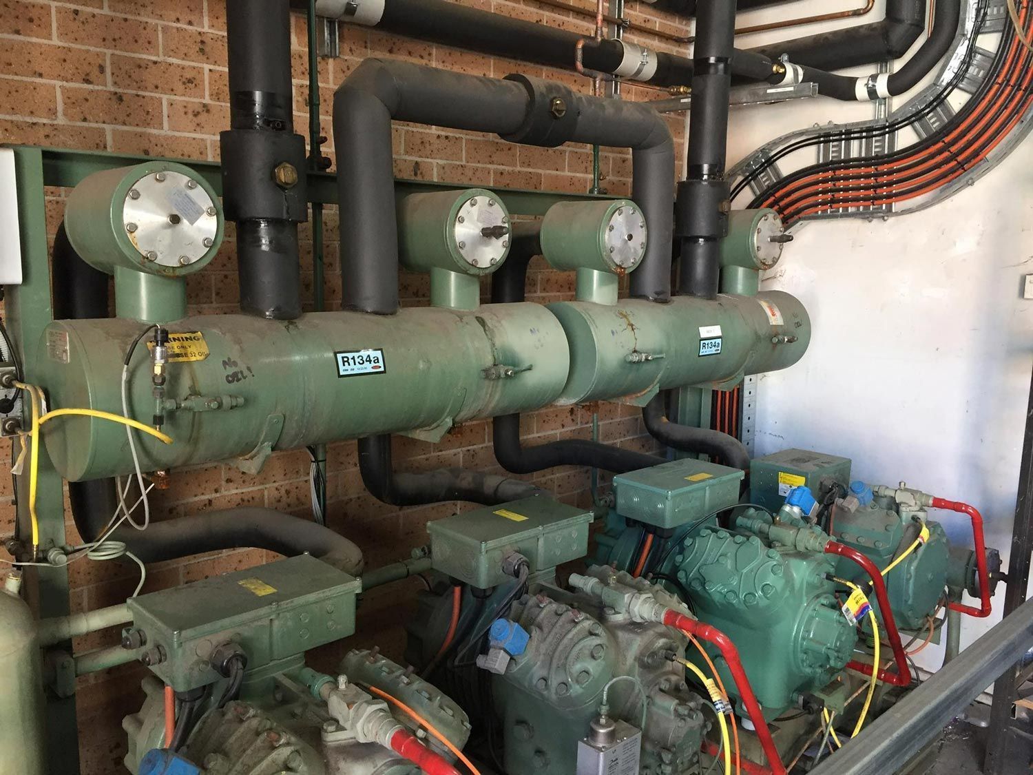 Industrial refrigeration compressor and pipework serviced by Premiair in Tamworth