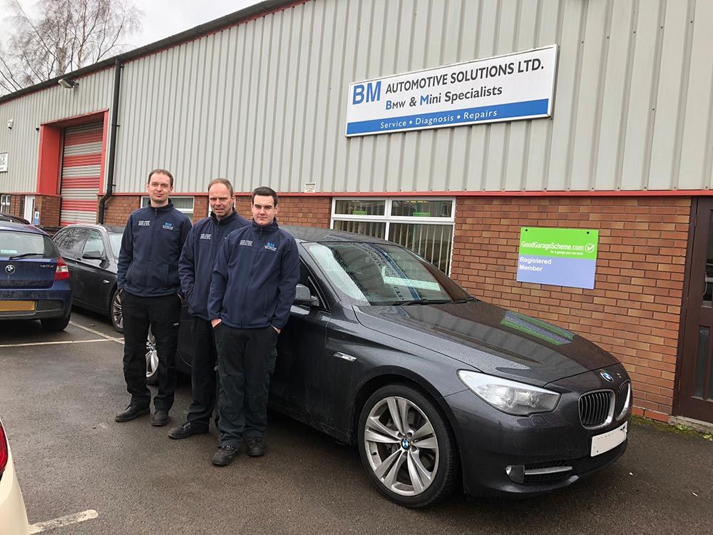 BMW specialist technician inspecting a vehicle
