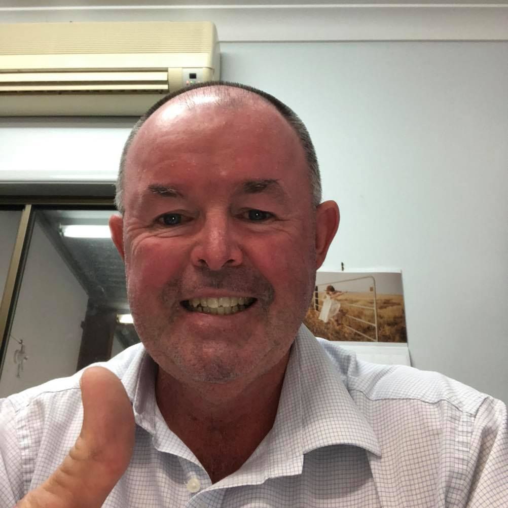A man is smiling and giving a thumbs up