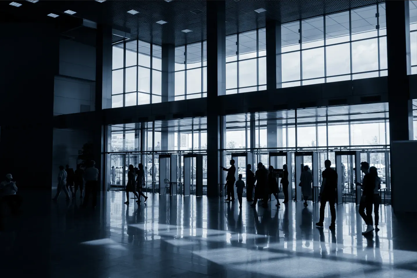 A group of people are walking through a large building