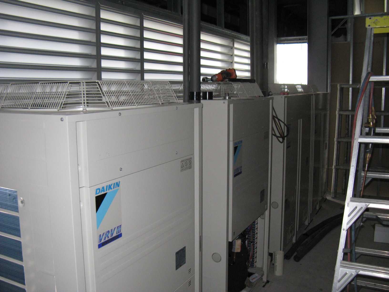 A Daikin Air Conditioner is Sitting in a Room Next to a Ladder — Enterprise Air That's Cool in Svensson Heights, QLD