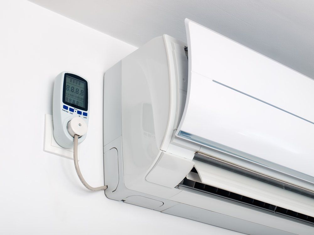 A White Air Conditioner is Plugged Into a Wall Outlet — Enterprise Air That's Cool in Avondale, QLD