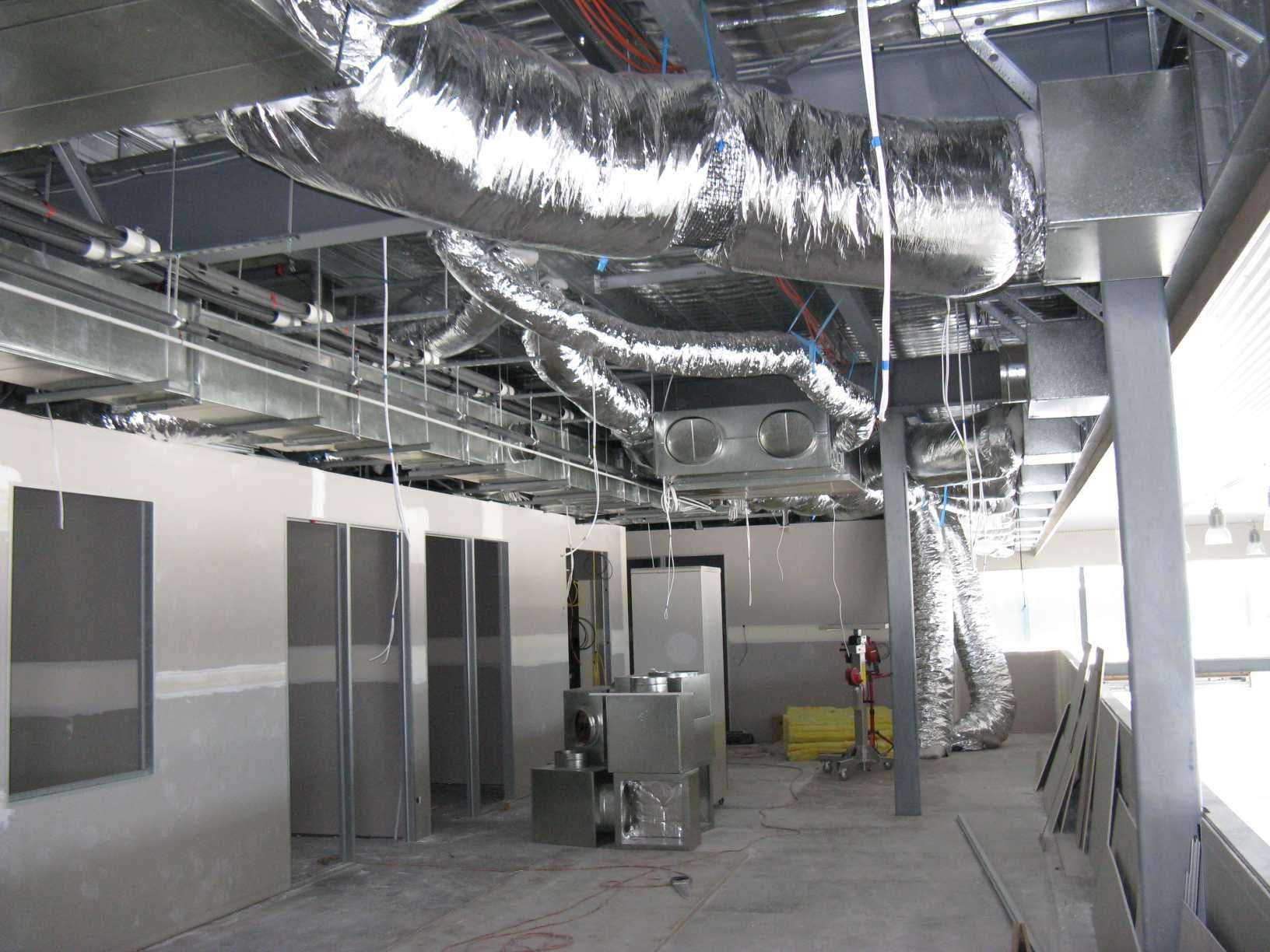 A Room With a Lot of Pipes Hanging From the Ceiling — Enterprise Air That's Cool in Svensson Heights, QLD