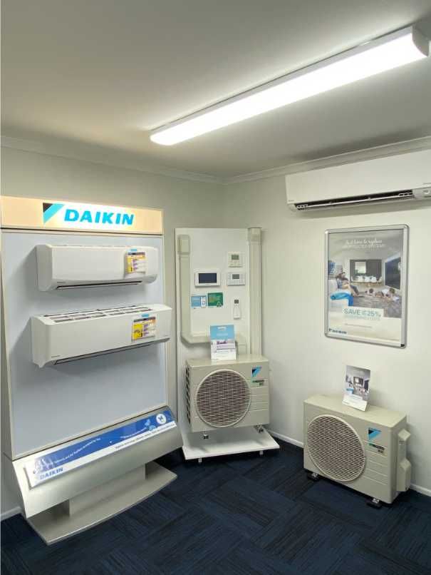 A Room Full of Air Conditioners With a Sign That Says Daikin on It — Enterprise Air That's Cool in Svensson Heights, QLD