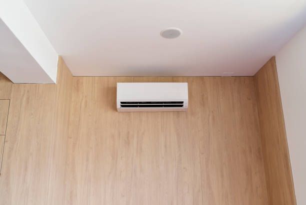 A White Air Conditioner is Hanging From the Ceiling in a Room — Enterprise Air That's Cool in Coral Cove, QLD