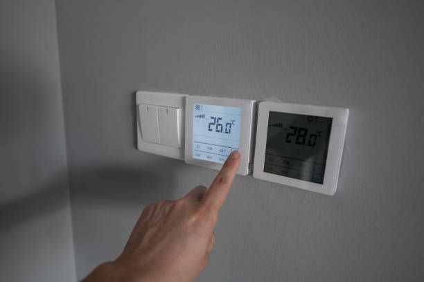 A Person is Pointing at a Thermostat on a Wall — Enterprise Air That's Cool in Sharron, QLD